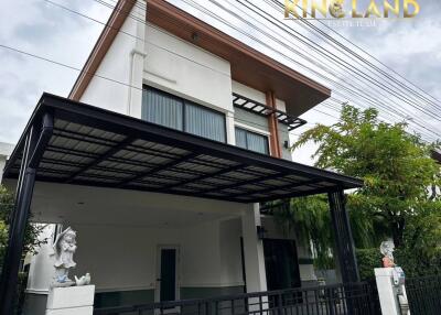 Two-story house front view with covered carport