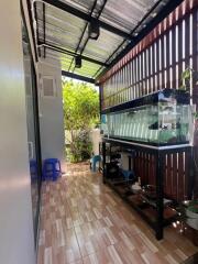 Covered patio with aquarium and seating area