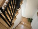 wooden staircase with black railings