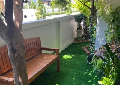 Beautiful outdoor garden area with bench and greenery