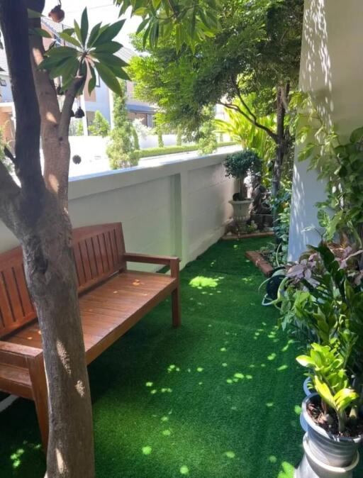 Beautiful outdoor garden area with bench and greenery