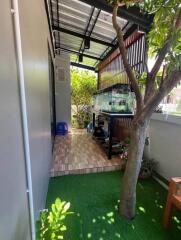 Covered outdoor area with fish tank and artificial grass