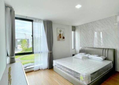 Bright and airy bedroom with large window and modern furnishings