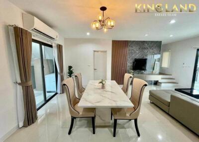 Elegant dining room with a marble table and chic chandelier