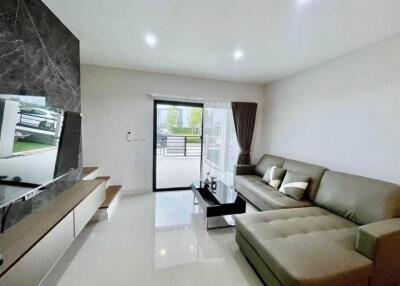 Modern living room with a sectional sofa and large TV