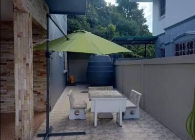 Outdoor seating area with table, chairs, and umbrella