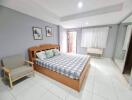 Spacious bedroom with large bed and seating area