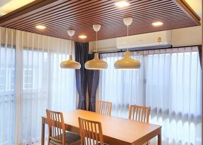 Modern dining room with wooden furniture and pendant lights