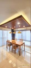 Modern dining room with wooden furniture and pendant lights