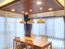 Modern dining room with wooden furniture and pendant lights