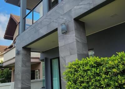 Modern two-story house exterior with lawn