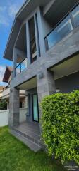 Modern two-story house exterior with lawn