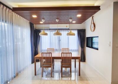 Modern dining area with wooden accents and large windows