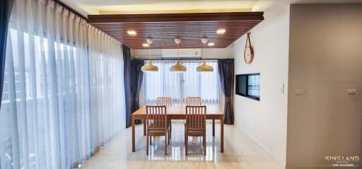 Modern dining area with wooden accents and large windows