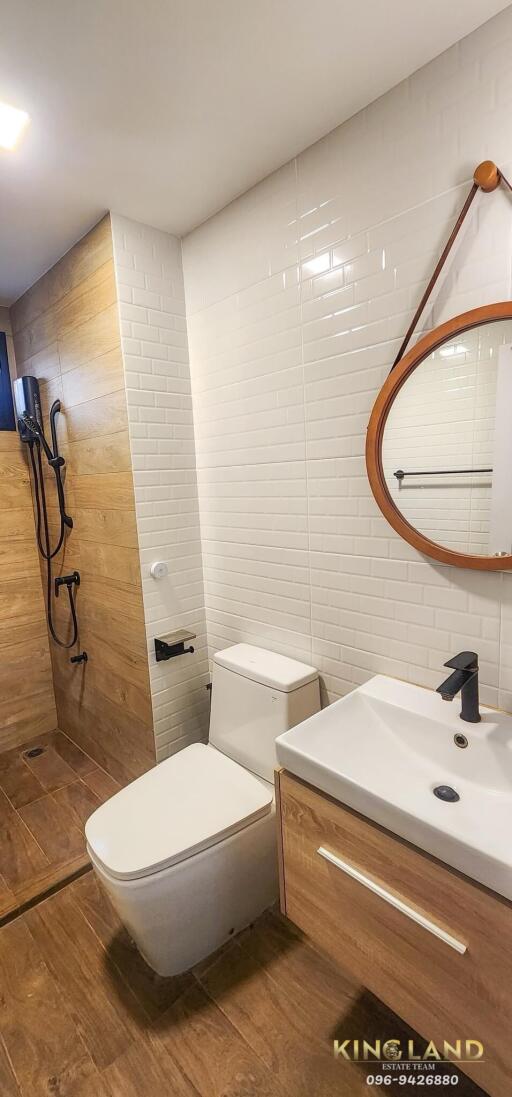 Modern bathroom with shower, toilet, and sink