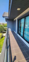 Spacious balcony with tiled flooring and glass railing