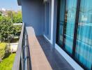 Spacious balcony with tiled flooring and glass railing