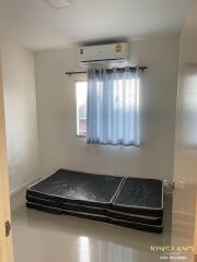 Small bedroom with mattress and air conditioner