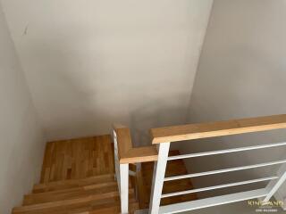 Wooden staircase with metal railing