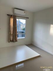 Bright bedroom with air conditioning and a large window