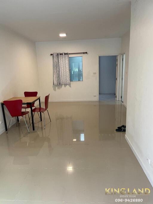 Spacious living room area with tiled floor