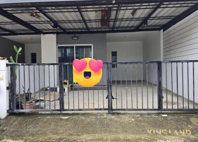 Photo of the exterior front of a house with a gated garage and driveway