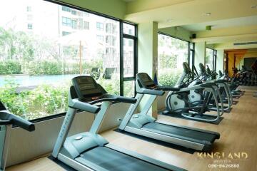 Gym with several exercise machines and large windows