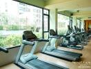 Gym with several exercise machines and large windows