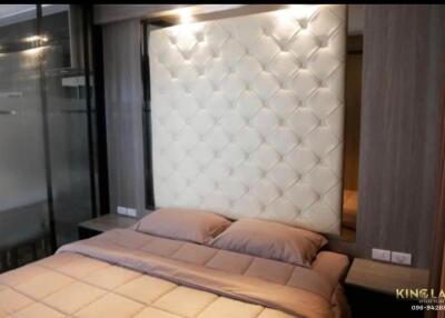 Modern bedroom with a padded headboard and ambient lighting