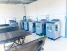 Laundry room with multiple washing machines