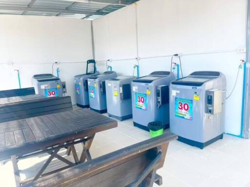 Laundry room with multiple washing machines