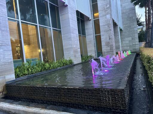 Building with colorful water fountain