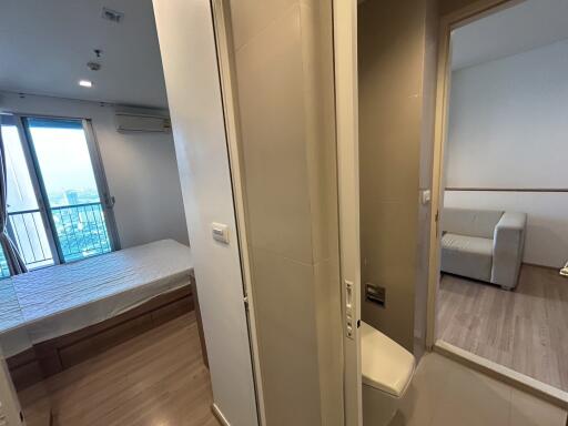 View of bedroom, closet area, and living room in a modern apartment