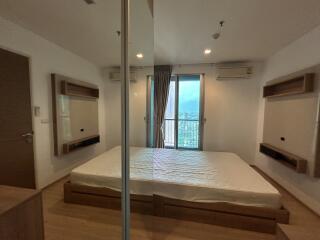 Bedroom with a large window and double bed