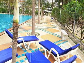 Outdoor pool area with lounge chairs