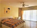 Spacious bedroom with double bed and large windows