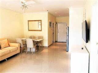 Bright living room with dining area and television