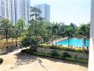 View of a residential complex with a swimming pool and tall buildings