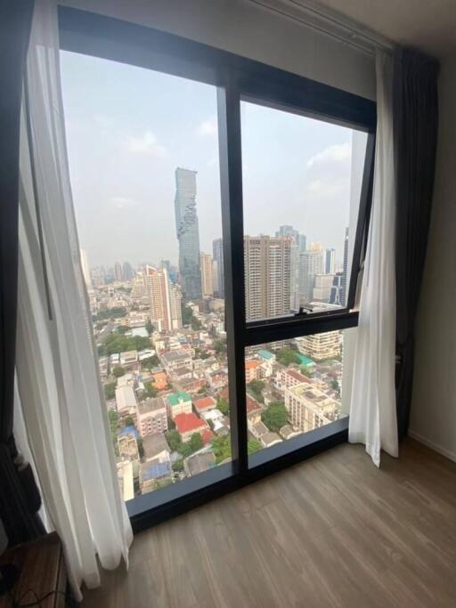 Bright living room with large windows and city view