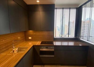 Modern kitchen with wooden countertops and large window