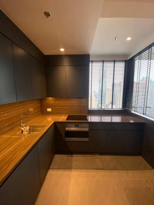 Modern kitchen with wooden countertops and large window