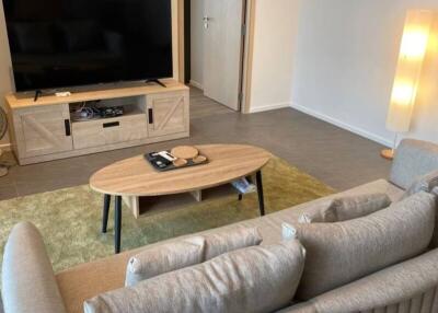 living room with beige sofa and TV