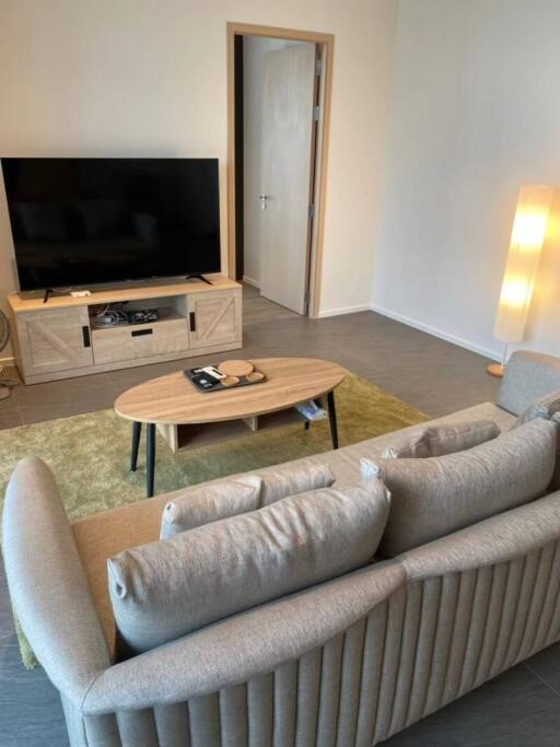 living room with beige sofa and TV