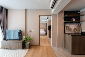 Modern living area with a view into the bedroom and kitchen