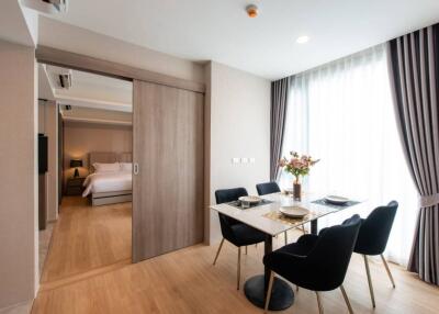 Dining area with table setup and view into a bedroom