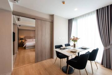 Dining area with table setup and view into a bedroom