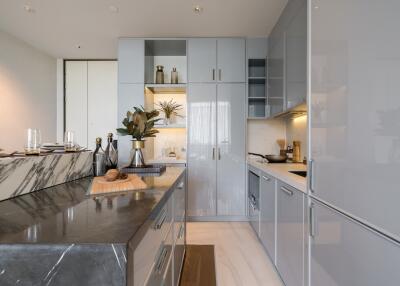 Modern kitchen with grey cabinetry and marble countertop