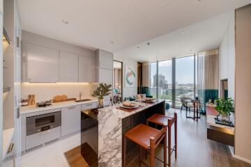 Modern open-plan kitchen connecting to a cozy living area with city views