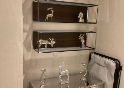 Decorative corner with metal deer statues and mirrored furniture