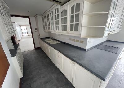 Modern kitchen with ample counter space and glass-paneled cabinets